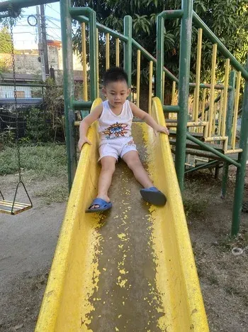 Rafa on a slide in a local park