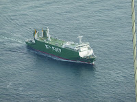 Big ship as seen from the top of one of the main towers on the Akashi Kaikyo Bridge. The side of the ship saids "Daihatsu" in katakana