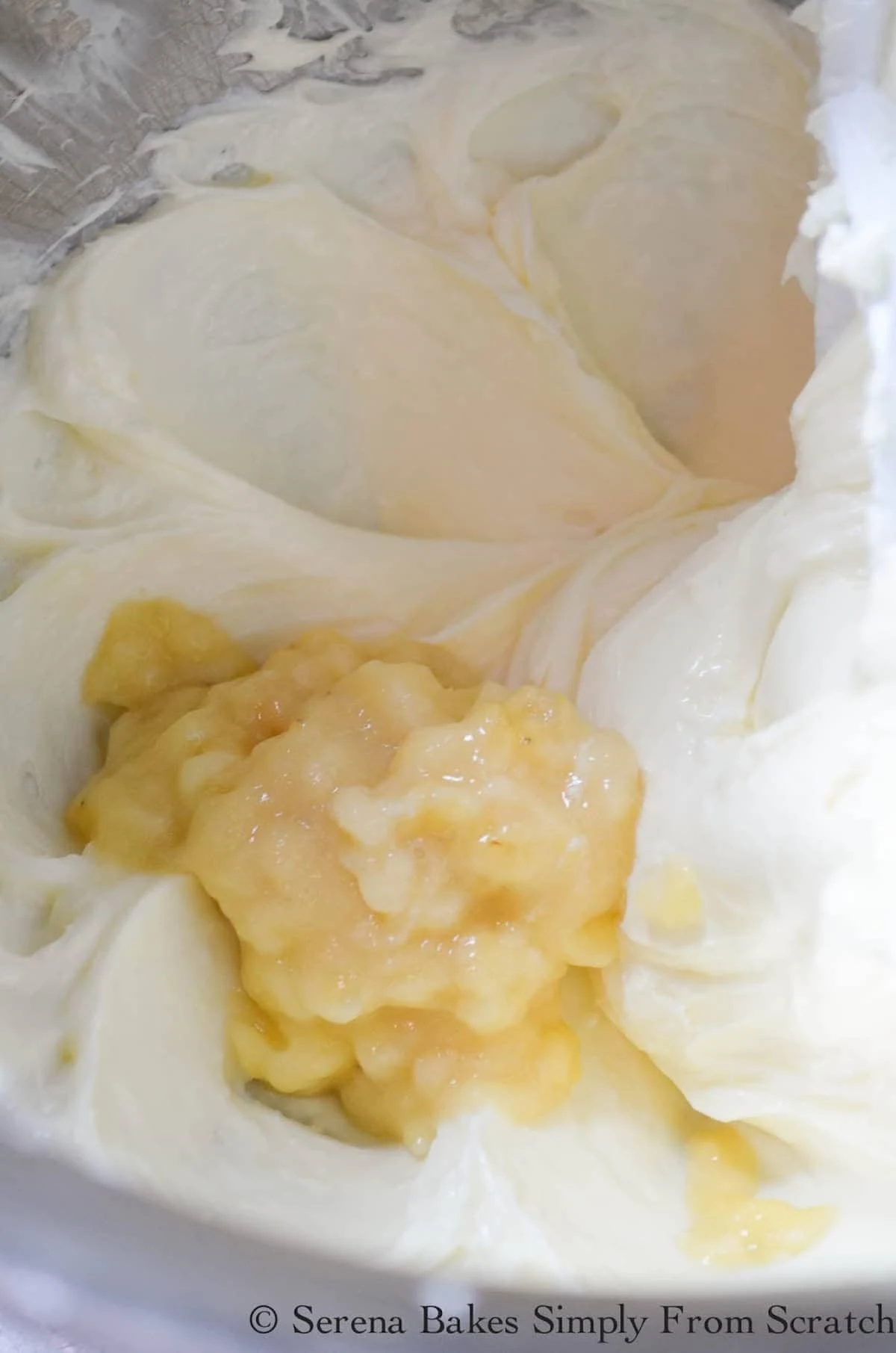 Mashed Banana added to the beaten cream cheese mixture in a mixing bowl.