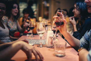 People drinking wine at a restaurant | Ann Arbor hotel