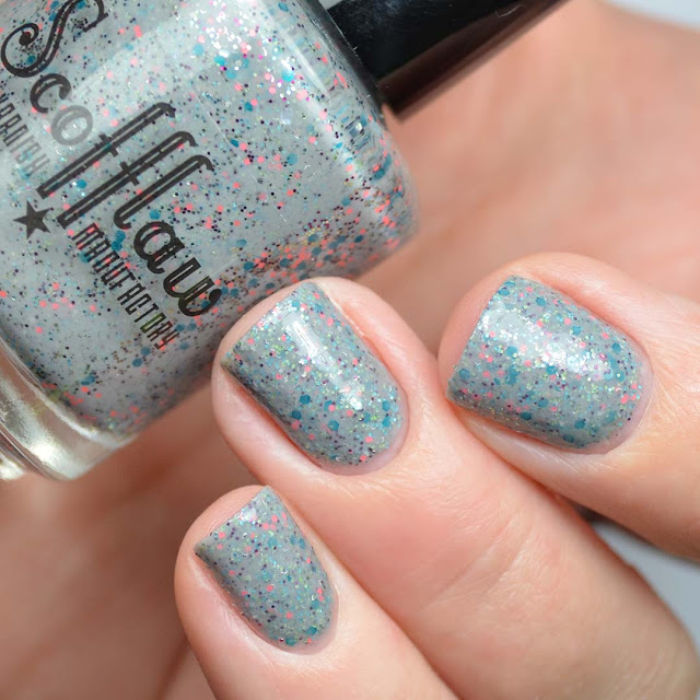 grey nail polish with pink and blue glitter swatch