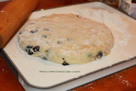 This is the dough rolled out to make these almond blueberry delicious homemade buttery flavored baked biscuits called scones. These have blueberries in them with a drizzle of thin frosting over the top with slivered almonds. They are usually eaten at breakfast time in European pastry shops