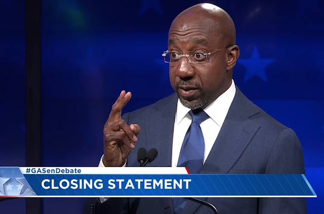 Georgia Senate Debate Raphael Warnock closing statement holding two fingers up