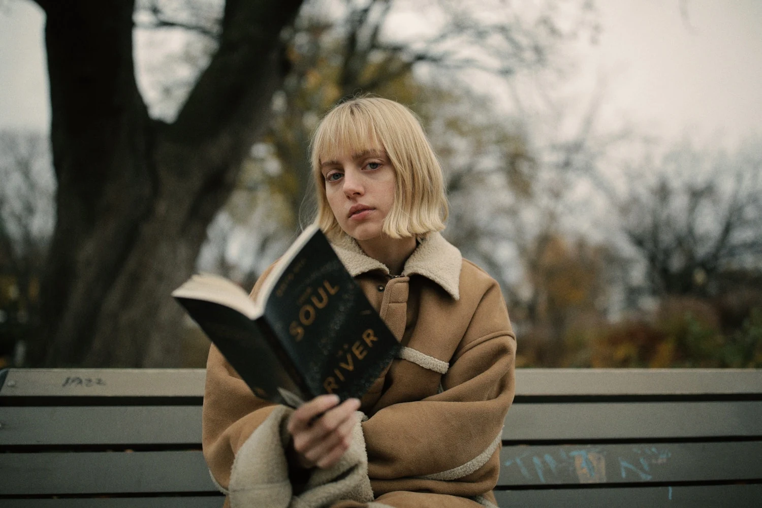 girl reads book in the park