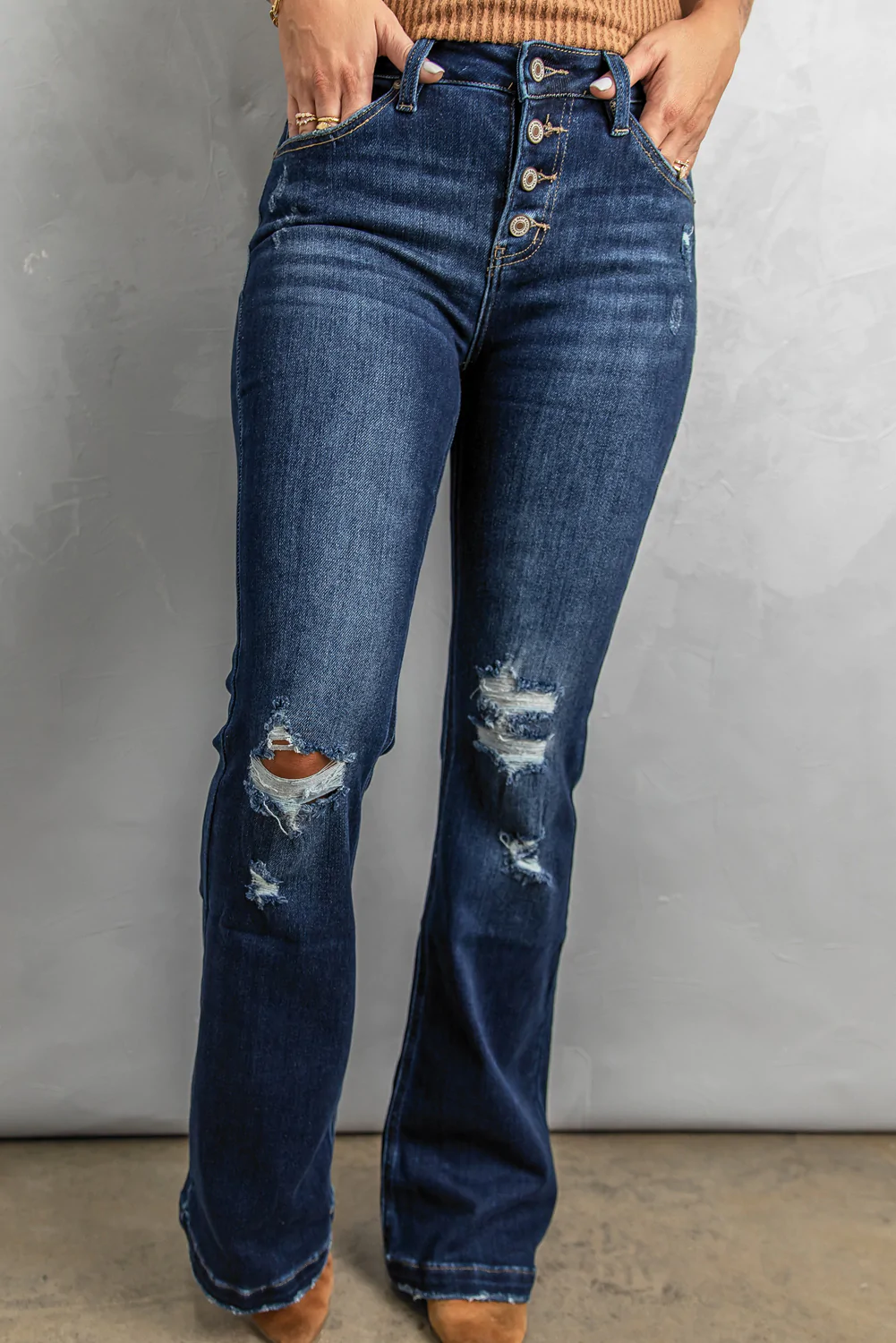 woman wearing a pair of stylish distressed and ripped jeans