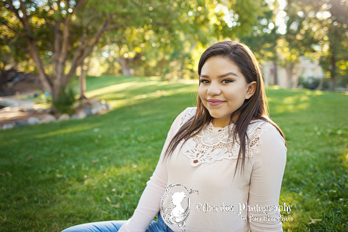 Professional photograph of an Atrisco high school senior on top at the UNM Duck Pond Albuquerque