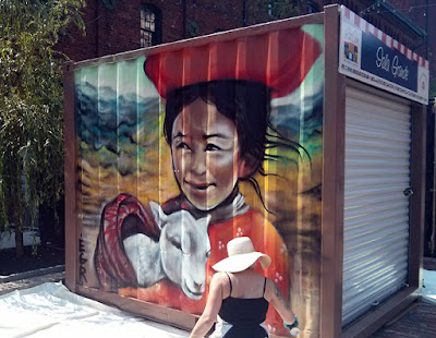 Graffiti artist EGR working on a container at Panamania Distillery District