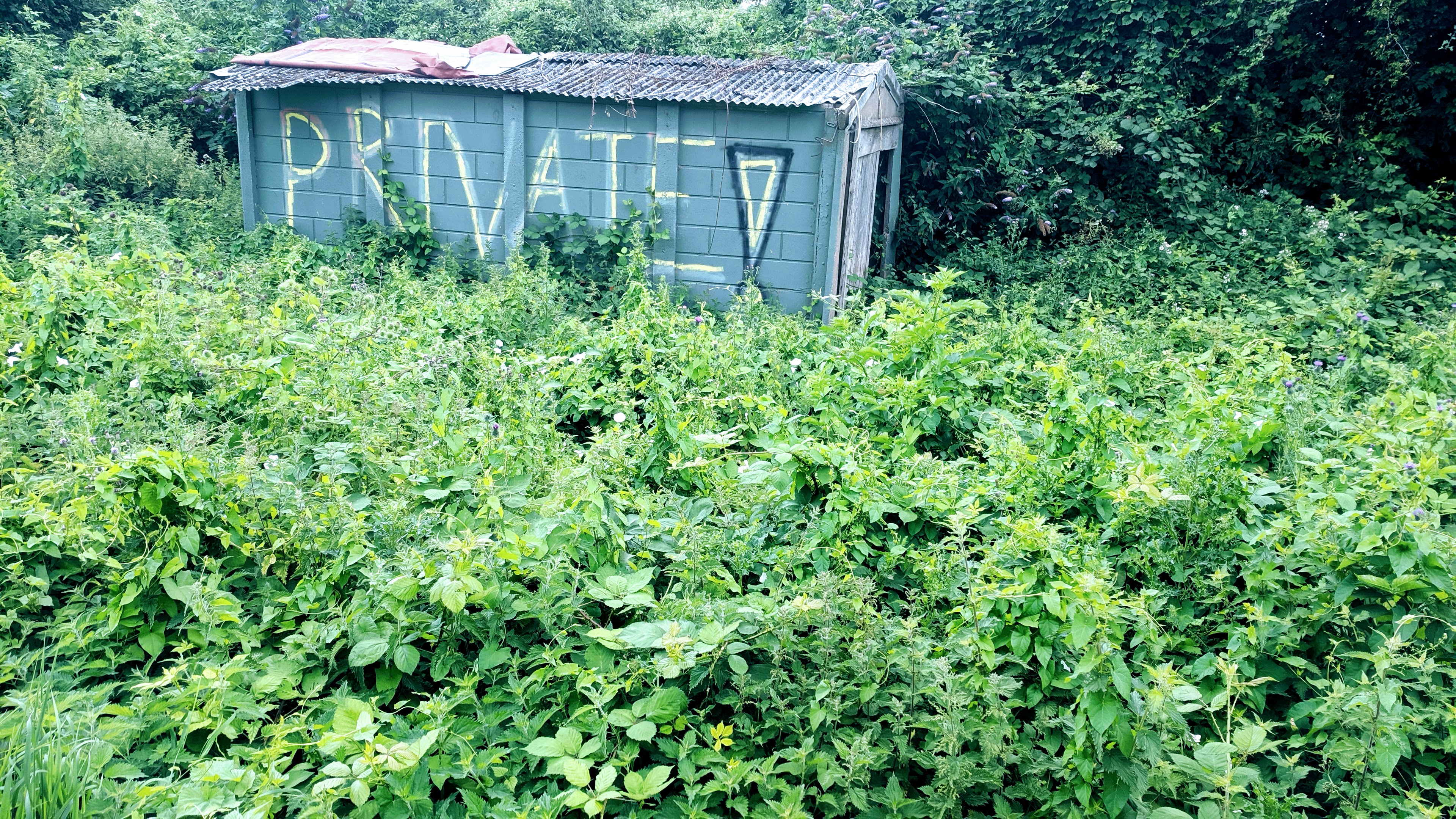 'Private!' sign on a ram shackled shed