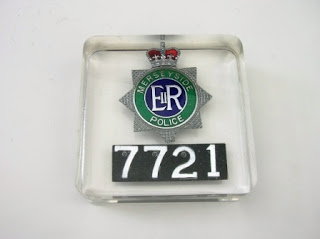 Paperweight containing a Police badge