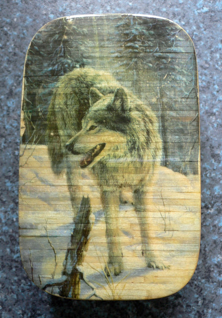 Wolf matchstick work tin lid.