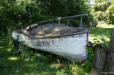 old boat on lighthouse grounds photo by mbgphoto