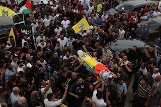 The funeral of the martyr Ahmed Oweidat in Jericho  Jericho WAFA - Large crowds of our people in the governorate of Jericho and the Jordan Valley, this evening, Tuesday, buried the body of the martyr Ahmed Ibrahim Oweidat (20 years), to his final resting place.  The funeral procession proceeded from in front of the Jericho Governmental Hospital to the martyr’s house, amid chanting angry slogans denouncing the crimes committed by the Israeli occupation against our people . New Jericho Cemetery.  The martyr Oweidat, a resident of Ain al-Sultan camp, west of Jericho, died this morning from his wounds sustained by Israeli bullets at dawn during clashes that erupted in Aqabat Jaber camp, south of the city.   last request  “Bring me a white dishdasha like your black dishdasha” This was the last request of Ahmed Oweidat (20 years old) from his father Ibrahim, who is in Mecca to perform Umrah, during a conversation between them on Monday night after breakfast.  Ahmed left his family home in Ain al-Sultan camp, west of Jericho, to visit one of his friends in Aqabat Jabr camp, south of the city, to spend some time on the night of the twenty-fourth of the blessed month of Ramadan. The head, during his storming of the camp.  By the dawn of the twenty-fifth of Ramadan, the city of Jericho woke up to the news of Ahmad's martyrdom, from his critical injury.  Immediately after receiving the news of the martyrdom of his eldest son, Ibrahim Oweidat published a picture of the last conversation between them on his Facebook page, and wrote: "May God have mercy on your soul, my dear... with the martyrs and the two friends, and good companions. You asked for a white dishdasha and received the dress of heaven."  Upon arriving at Jericho resting place from Saudi Arabia to bid farewell to his son, the grieving father told Wafa: “The news struck us like a thunderbolt, and I am in Saudi Arabia after Tarawih prayers. I received a message from my son asking for a white dishdasha as a gift. Less than 6 hours later I received the news of his martyrdom. This is the least that can be offered as a sacrifice for the country."  He continues with burning and pain in his heart, "Perhaps this was his last request to wear a white shroud in the Hijaz dress as a bridegroom carried on the shoulders in the streets of the city of Jericho."  During the storming, two other young men were wounded by live bullets, while the "Fatah" movement declared the region of Jericho and the Jordan Valley a general and comprehensive mourning in the province.  The uncle of the martyr, Faisal Oweidat, told "Wafa" that Ahmad was hit by two bullets in the head area during the Israeli occupation forces' random shooting, noting that the martyr was a student at Al-Quds University, and he is the eldest son among six brothers, and he works in a private company in Jericho, where he reconciles Between his work and his education, like the rest of the Palestinian youth who love life.  For his part, head of the Department of Families of Martyrs and Wounded People in the Homeland and Diaspora, Nasser Shalon, told Wafa that the martyr Ahmed Oweidat was the first martyr to rise in the Jericho and Jordan Valley since the beginning of this year.  He added that the occupation targets civilians and defenseless civilians, and Palestinian camps in particular, which requires confronting the occupation in various fields and arenas of struggle and at all levels.  Large crowds of our people in the governorate of Jericho and the Jordan Valley attended the funeral of the martyr Ahmed to his final resting place carried on the shoulders, and the funeral procession proceeded from in front of Jericho Governmental Hospital to the house of the martyr in Ain Al-Sultan camp, where his family took a farewell look at him, and then the mourners performed a prayer The funeral was held over the body in the old Jericho mosque, before being buried in the new Jericho cemetery.  With the martyrdom of the young man Oweidat, the number of martyrs who have risen since the beginning of this April has risen to 21, including two female martyrs and a child (13 years), during the repeated incursions of the occupation forces into Palestinian cities, towns, villages and camps.     The President calls the father of the martyr Ahmed Oweidat, in condolence    Ramallah WAFA - Palestinian President Mahmoud Abbas phoned Ibrahim Oweidat, this evening, to offer condolences for the martyrdom of his son Ahmed, who was martyred this morning by the Israeli occupation bullets, in Aqabat Jaber camp near the city of Jericho.  During the phone call, His Excellency expressed his sincere condolences and heartfelt sympathy for the martyrdom of his son, asking God Almighty to bless him with his vast mercy and dwell in his vast gardens, and to inspire his family and lovers patience and solace .  For his part, the father of the martyr thanked the president for the call.