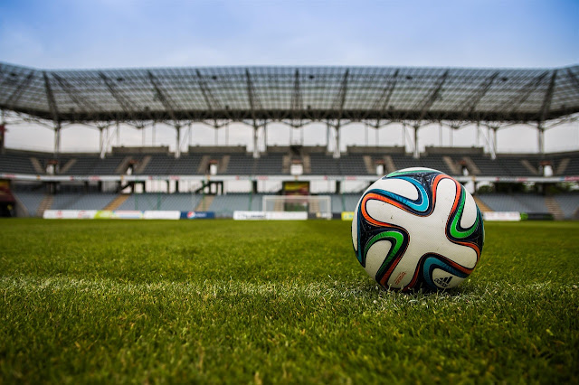 Football on grass field during daytime