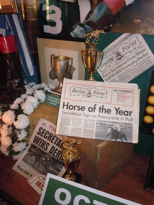 Secretariat trophy and newspaper props