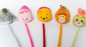 eeyore piglet winnie the pooh tigger and rabbit disney tsum tsum characters in a row with colorful pipe cleaners