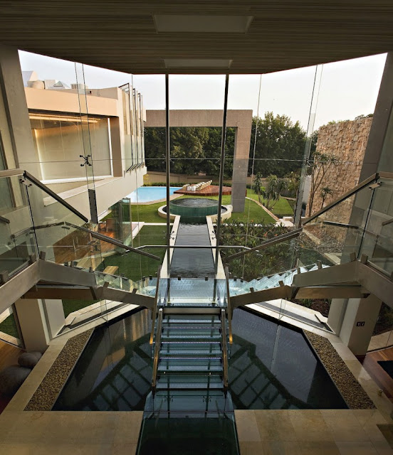 Photo of incredible two way glass staircase with the view into the backyard