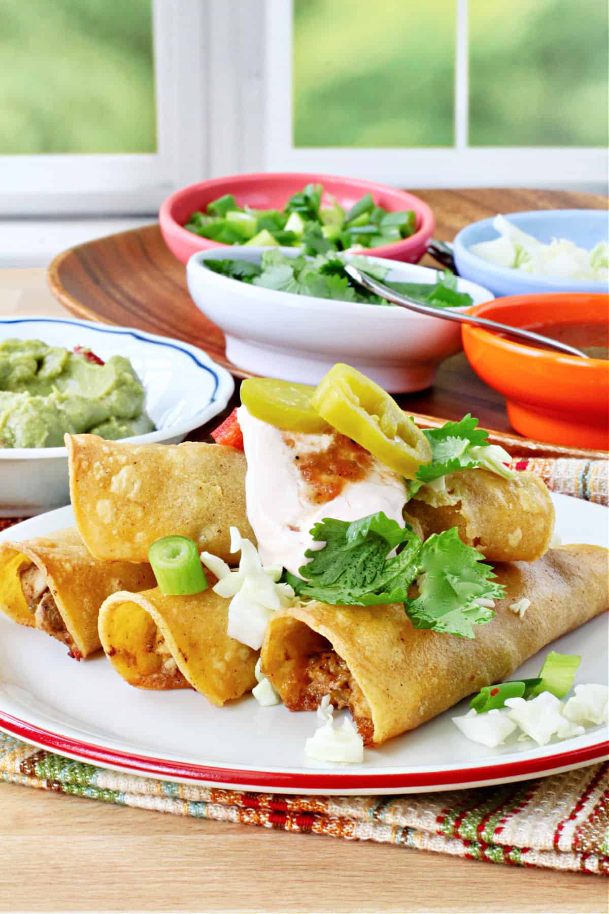 Crispy Baked Chicken Taquitos with guacamole on the side.