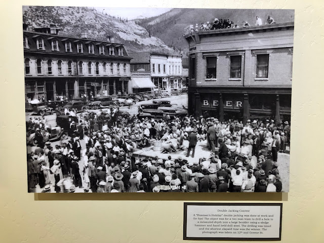 old black-and-white photo of town square with a festival going on