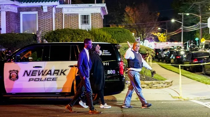 Newark Mayor Ras Baraka, right, arrives to the scene where two police officers were reported shot, Tuesday, Nov. 1, 2022, in Newark, New Jersey. (AP Photo/Eduardo Munoz Alvarez)