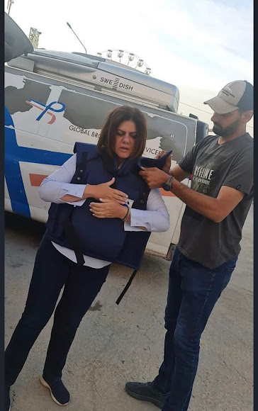 Shireen Abu Akleh wearing her press vest