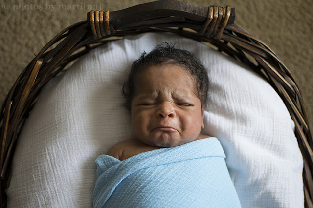 Newborn baby boy laying in a basket, photo by Martina