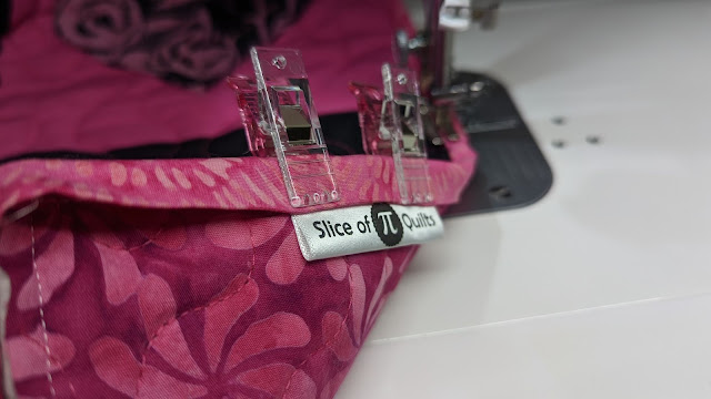 Sewing a satin label into the binding when machine sewing