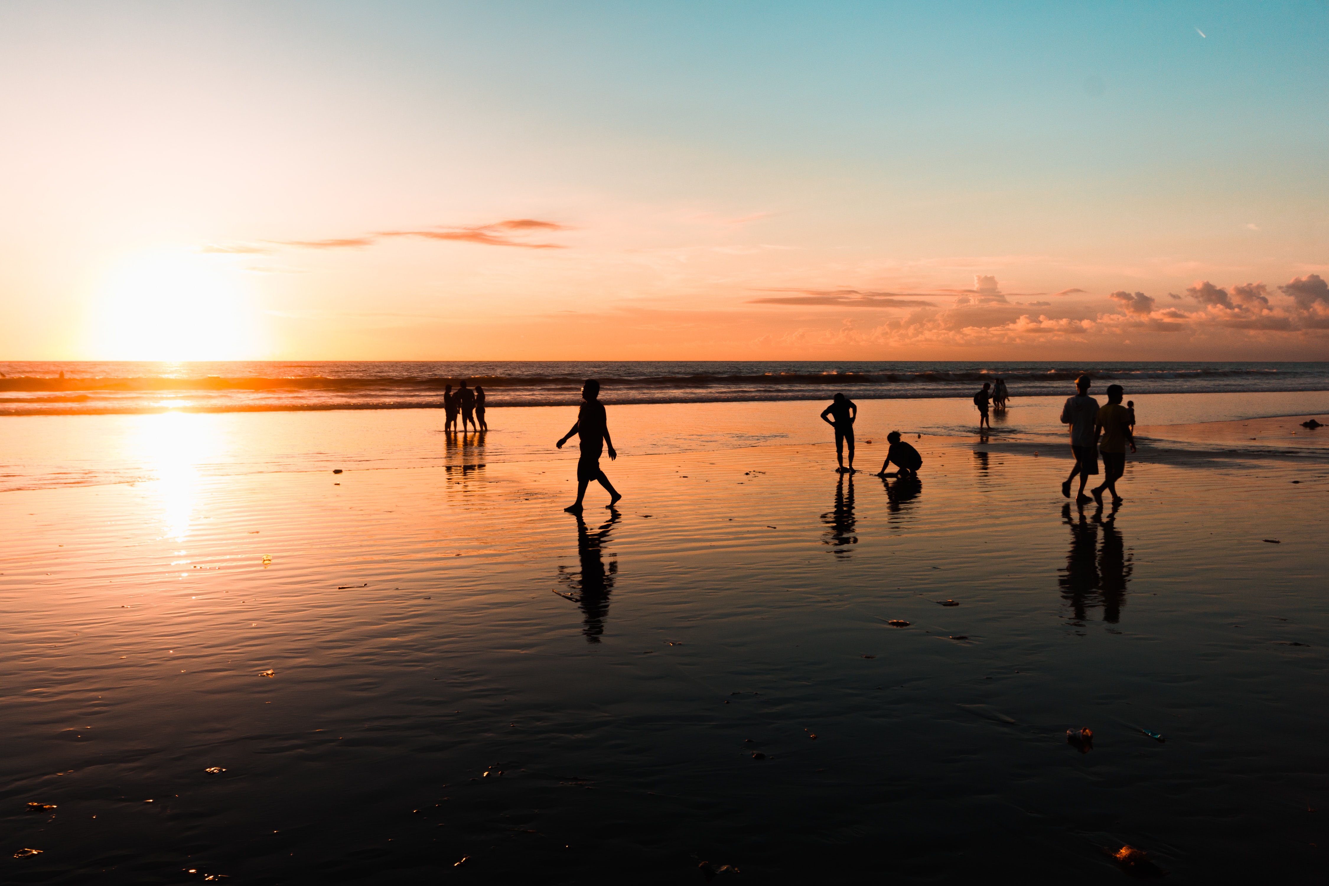 People at beach during golden hour photo. Photo by: George Bakos (unsplash.com)