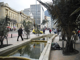 A homeless man finds a strange place to kip on a busy afternoon in downtown Bogotá