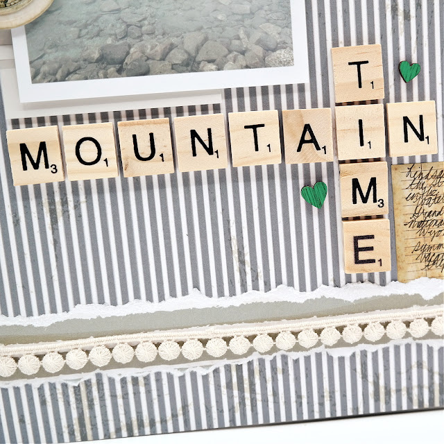 Mountain Time Grand Teton Vacation Scrapbook Layout with Stenciled Mountains and Trees Background, Die-Cut Pocket Watch, and Wood Letter Tile Title.