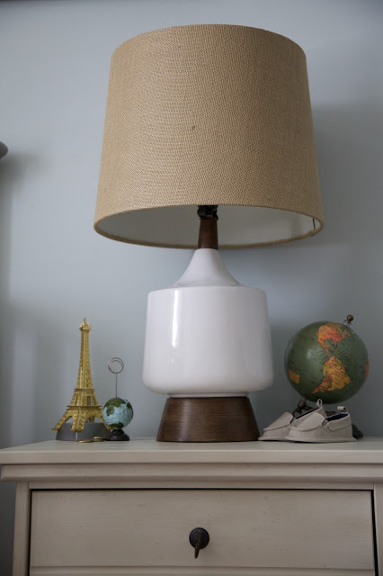 A travel and adventure-inspired gender neutral nursery with pops of burlap, pale gray, white, blue, and green.