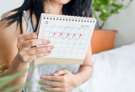 Girl with a calendar showing Irregular Periods dates