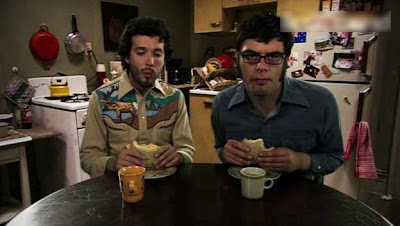 Bret and Jemaine at the kitchen table during opening credits of Flight of the Concords