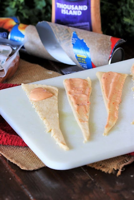 Spreading Thousand Island Dressing to Make Reuben Pigs In a Blanket Image