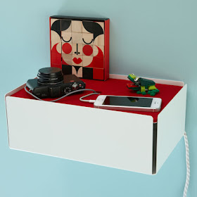 wall-mounted charging station, looks like a box with charging items laying on the top