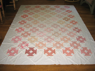 churn dash quilt in coral colors