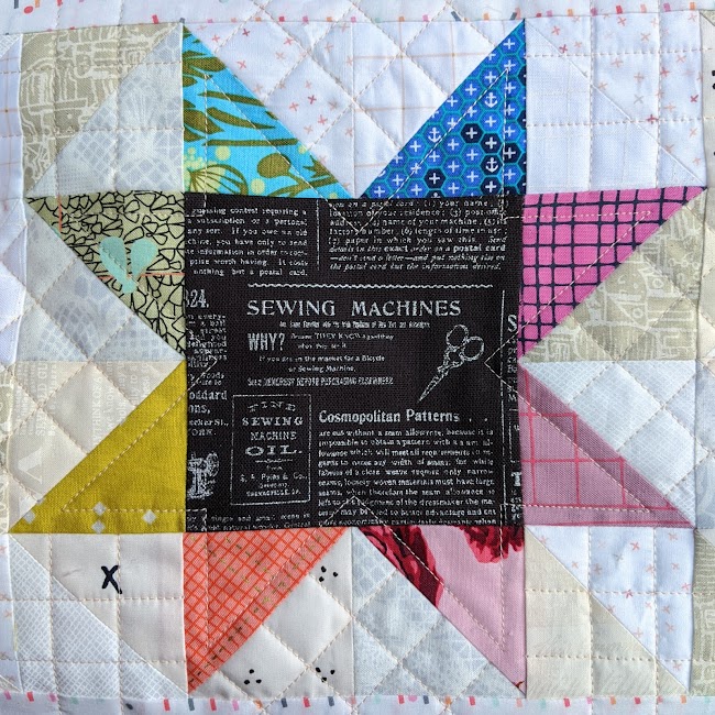 patchwork star with rainbow coloured points quilted