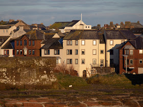 Photo of the housing development around Maryport Harbour from the path along the sea wall