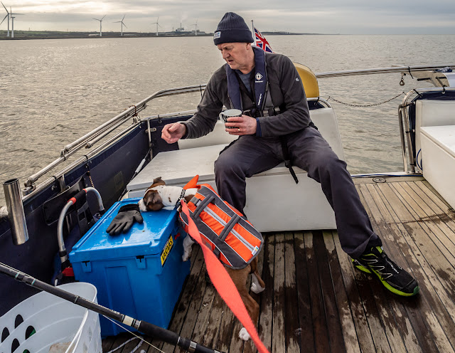 Photo of Ruby checking out Phil's fishing gear