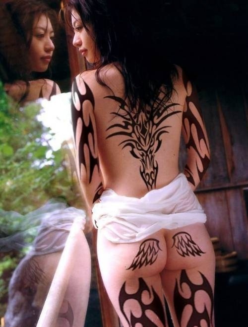 Sexy Woman with Tribal Tattoo at Bursts Sides