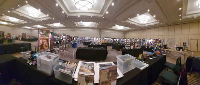 The ConQuesT 53 Art Show in a panoramic photo that shows the entire display.