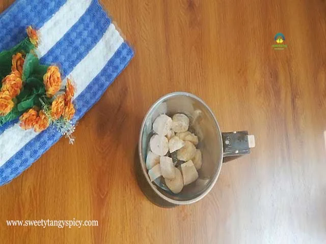 Melted jaggery being strained into a mixer jar for making Unniyappam batter.