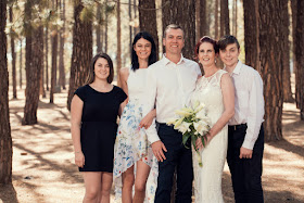 Angelique Gilchrist and family standing in front of a tree posing for the camera