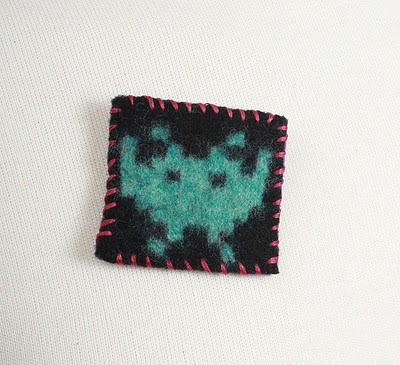 green alien space invader badge