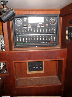 Original Uniflite electrical panel next to navigation station--switches below control lights on deck