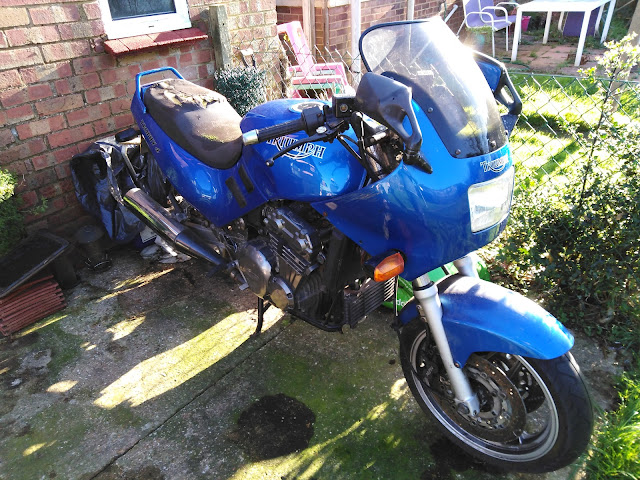 Triumph Trophy parked up in a garden