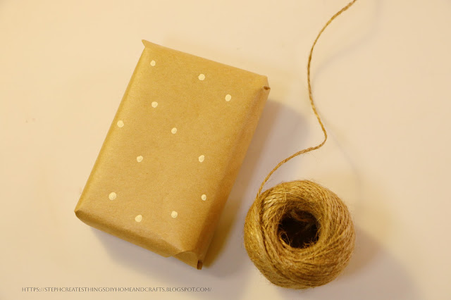 Gift box with brown wrapping paper and mini dots near twine