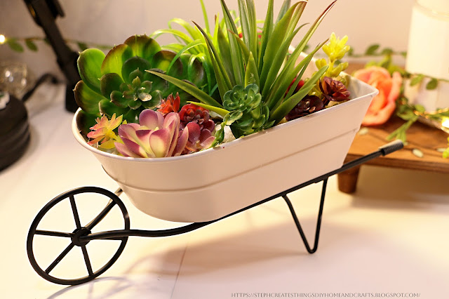 Mini Wheelbarrow with faux succulents displayed inside