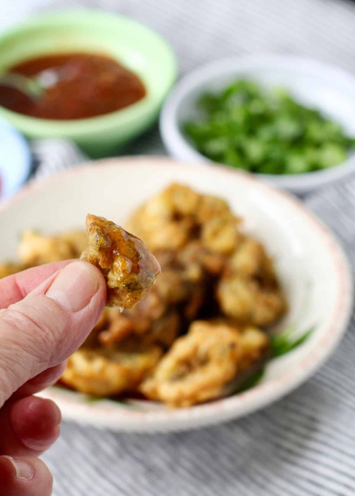 Salt and pepper squid bite dipped in a sweet sauce.