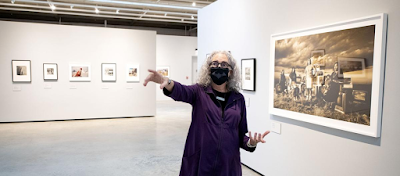 Photo of Mary Anne Redding, curator at the Sioux City Art Center, while discussing the center's new exhibition, "Magnetic West."