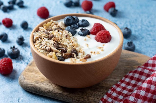 Yogurt with berries and muesli for breakfast in bowl